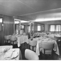 Messapia - Sala da pranzo della nave Messapia con tavoli imbanditi e porta scorrevole per l' accesso alla zona Bar